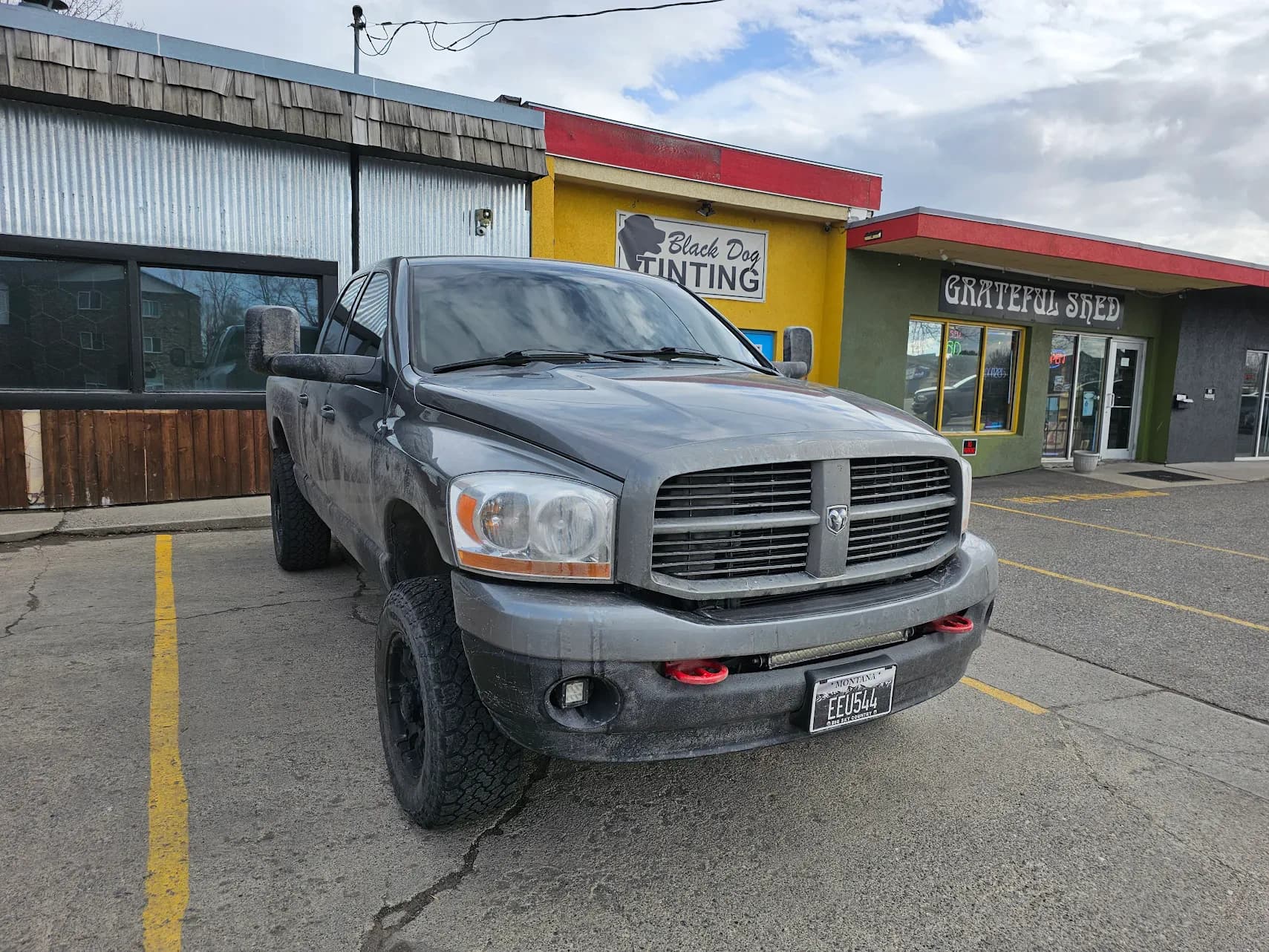 Lifted Dodge Ram outside Black Dog Tinting