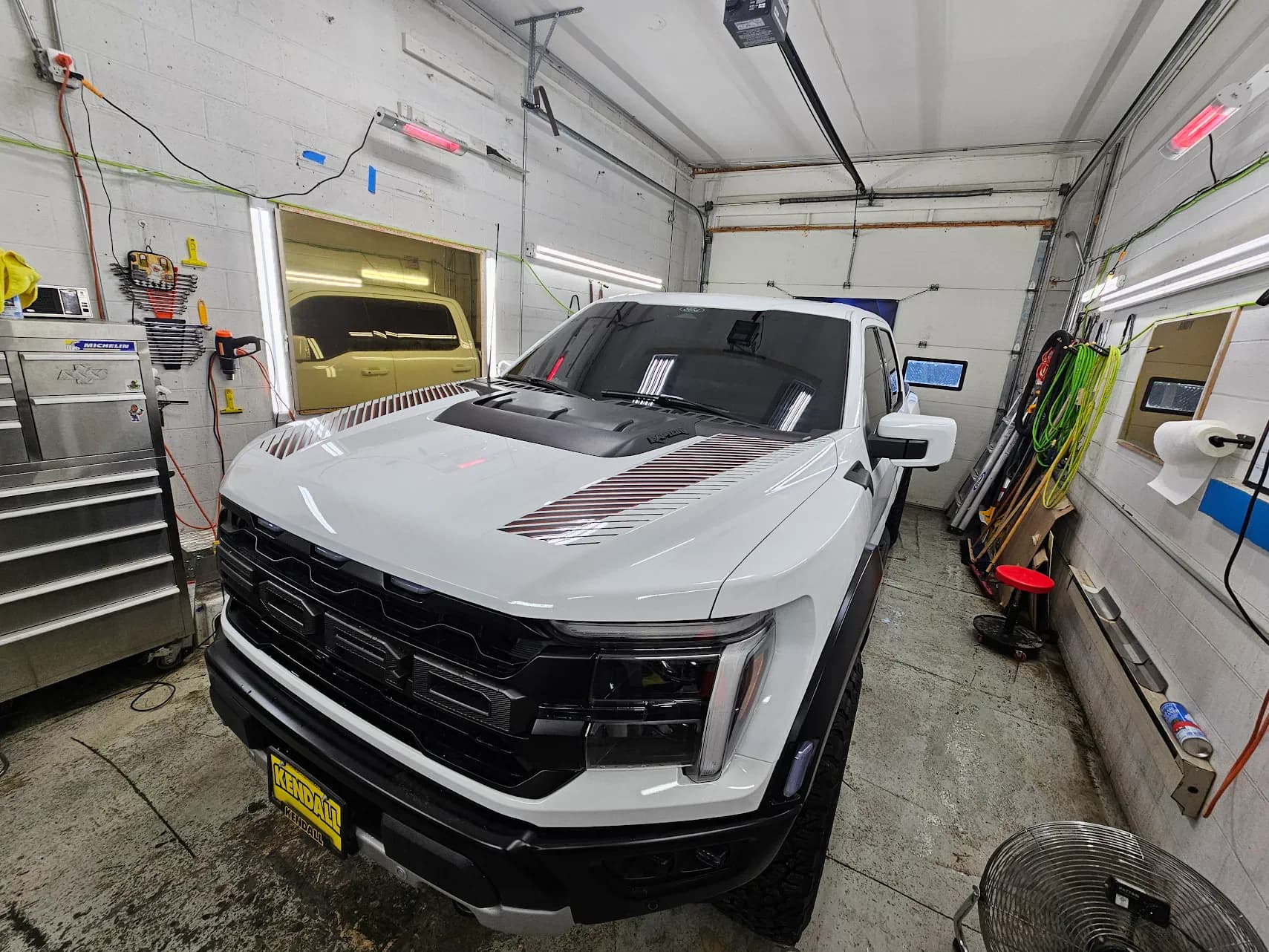 White Ford truck in the Black Dog install bay