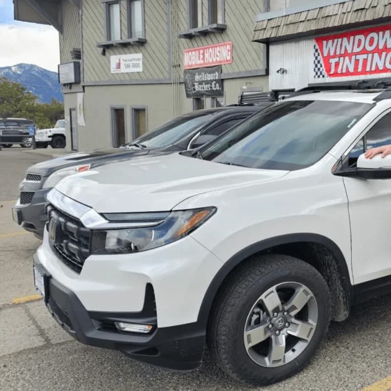 White Honda SUV tint project outside the shop